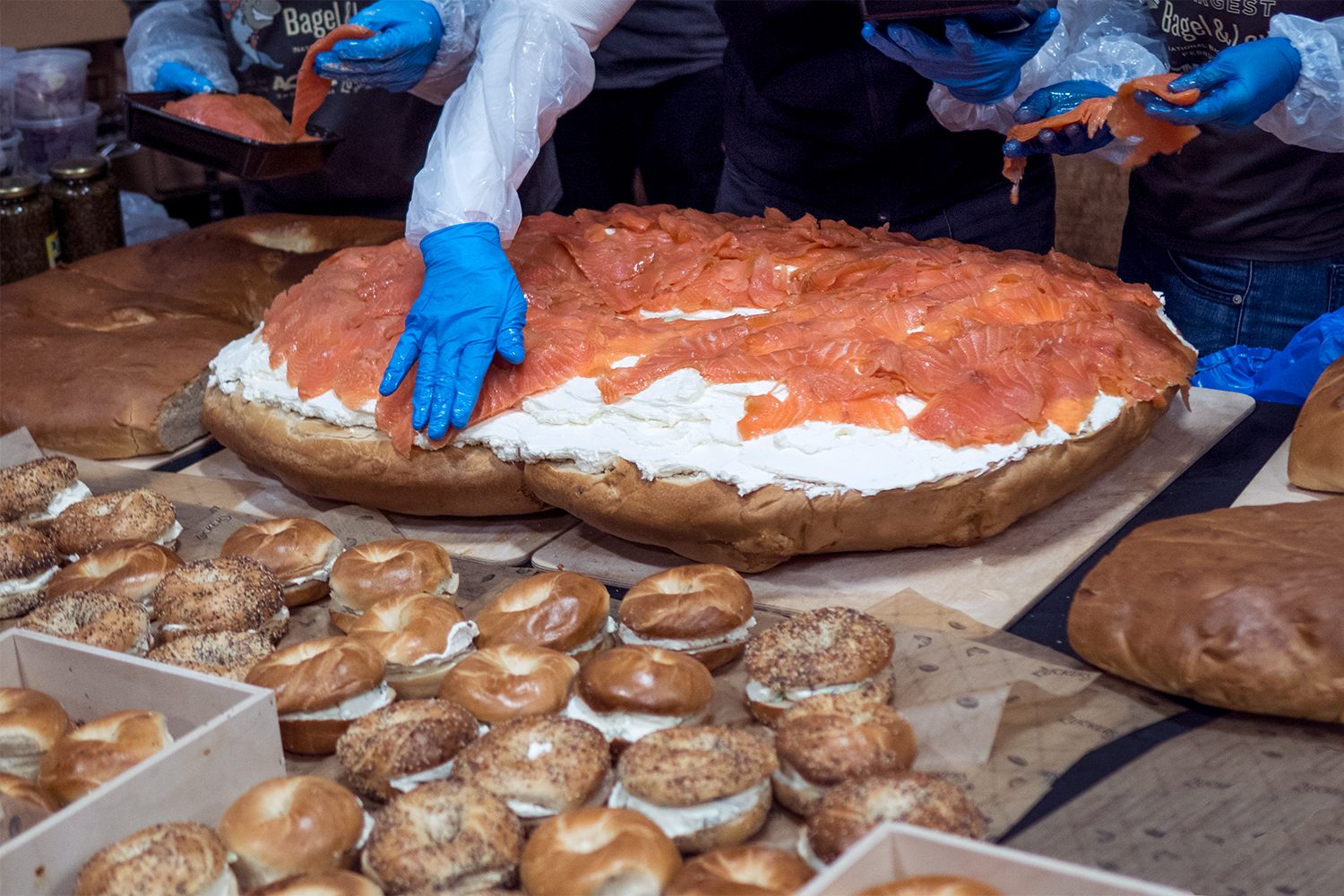 Assembling the gigantic bagel and lox.