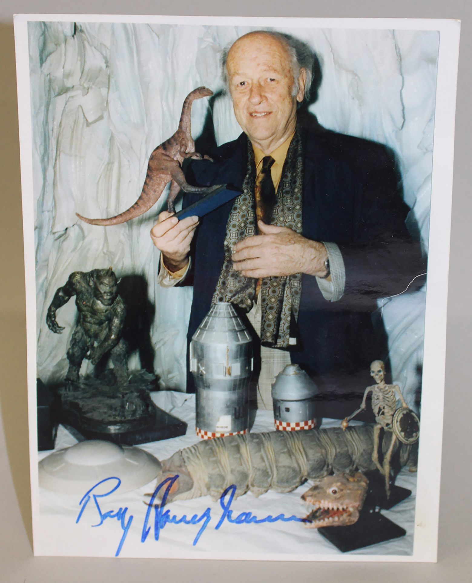  A signed colour photograph with some of his models, 7 ½” x 5 ½”  £50 – 100