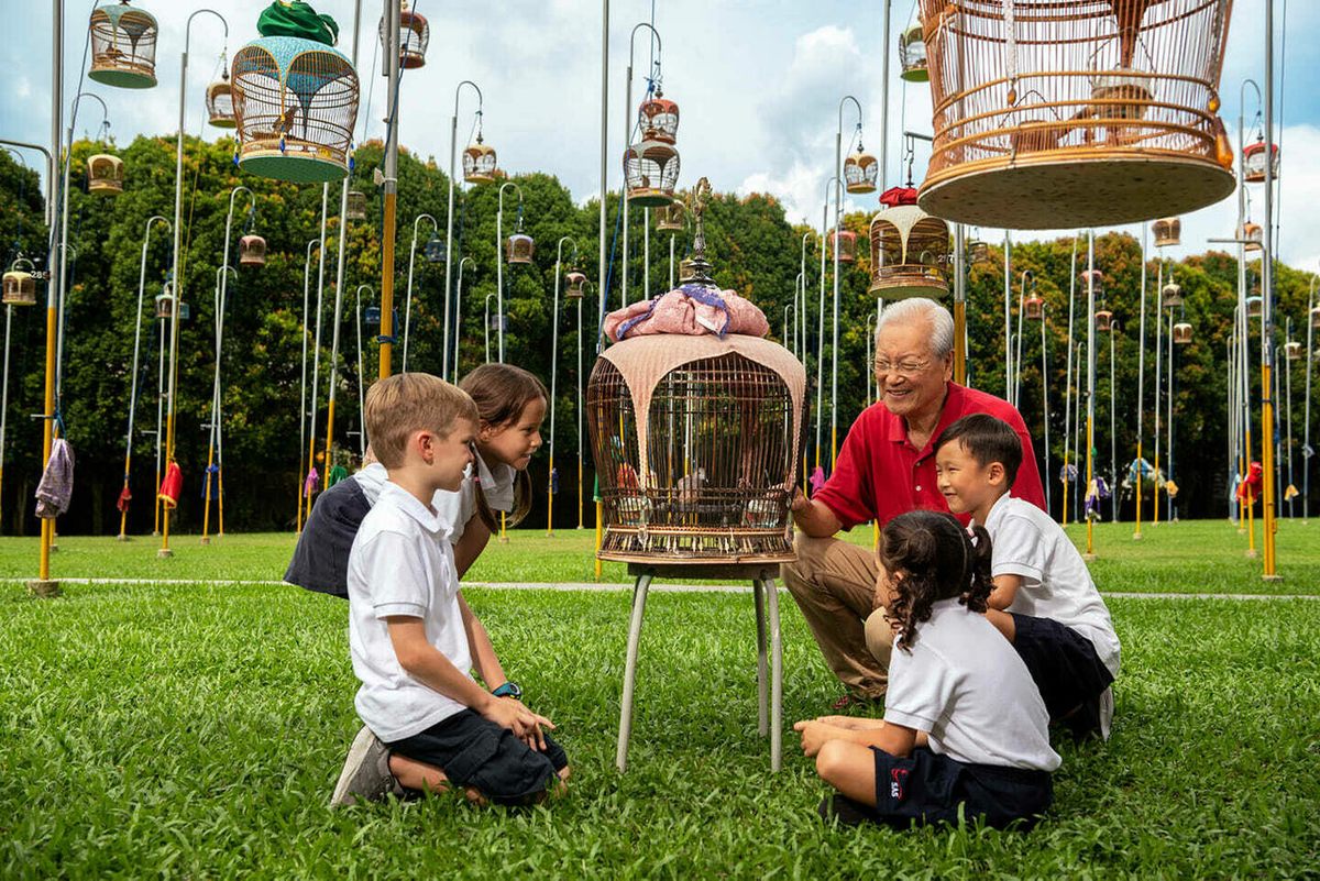 Kebun Baru Birdsinging Club community volunteer Robin Chua teaches kindergarteners visiting the club about the zebra dove.