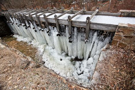 The sluice leading to the mill wheel leaks profusely, creating an ice cave underneath the scaffolding from around December to February. (Joel Simpson/Atlas Obscura)