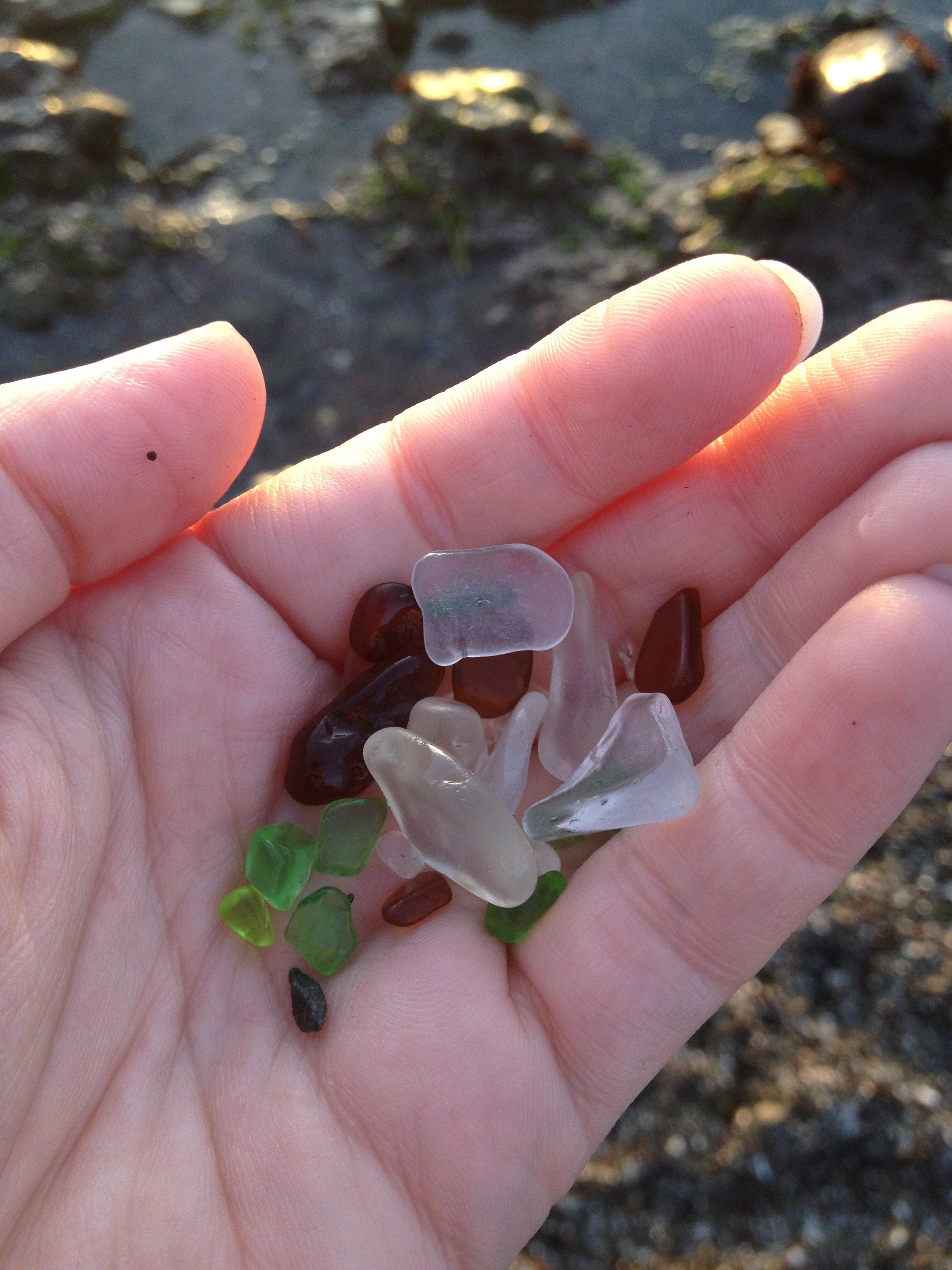 The waves wash over the mix of rocks and ground-down glass pieces on the site of a former trash dump, now Glass Beach in Fort Bragg, California