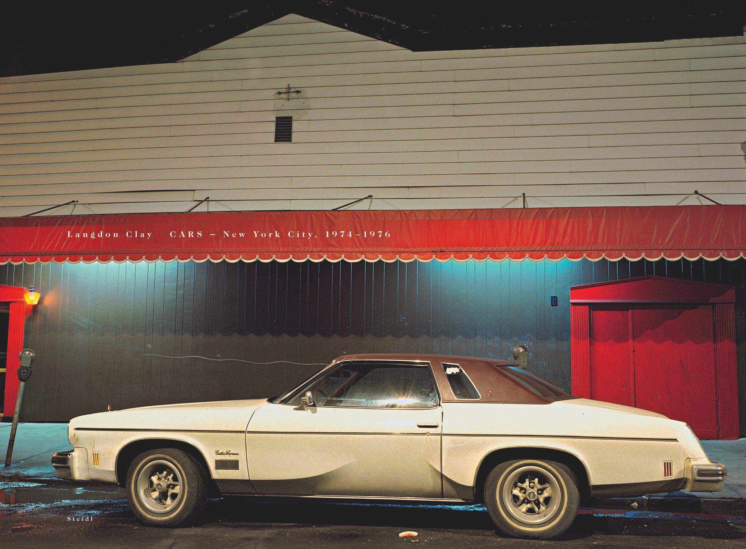 The cover for Langdon Clay's <em> Cars - New York City, 1974-1976</em>, showing the <em>Marlin Room Car, Cutlass Supreme in front of the Marlin Room and Lounge connected to Clam Broth House, Hoboken, NJ, 1975.</em>