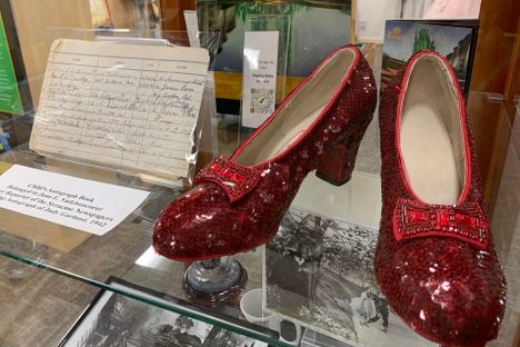 Judy Garland's Autograph next to a pair of replica ruby slippers made by costume designer Shawn Ryan