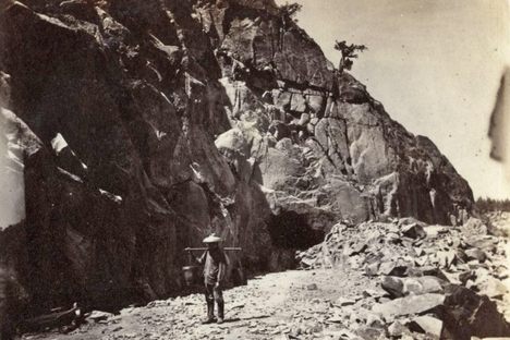 A photo, dated between 1862 and 1869, shows a young Chinese worker carrying tea.