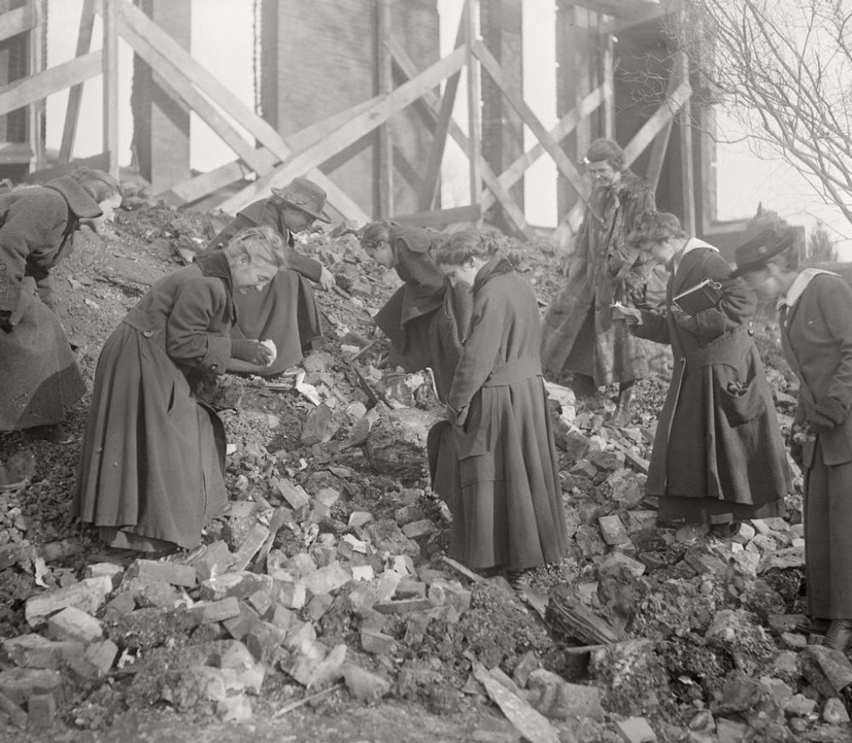 Mignon Talbot (second from left) and students sifted through the debris of a burned building in an effort to recover fossils.