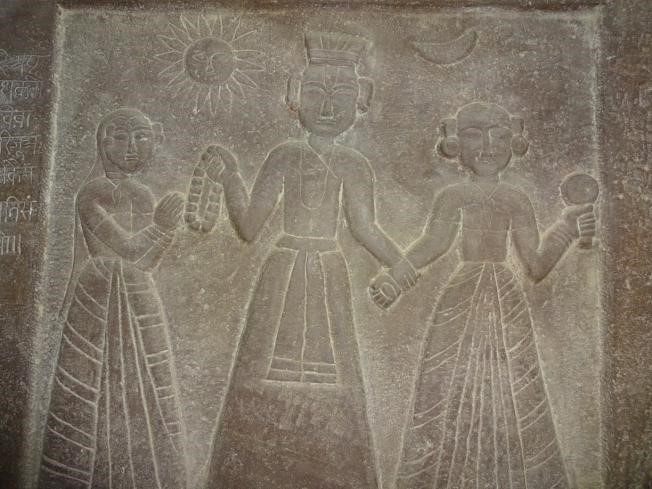 A sati stone depicting a king and his two wives at Orchha, Madhya Pradesh.