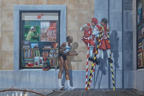 Shop windows with references to sport and folklore; featuring Olympic athlete Nafissatou Thiam and "combat des échasseurs."