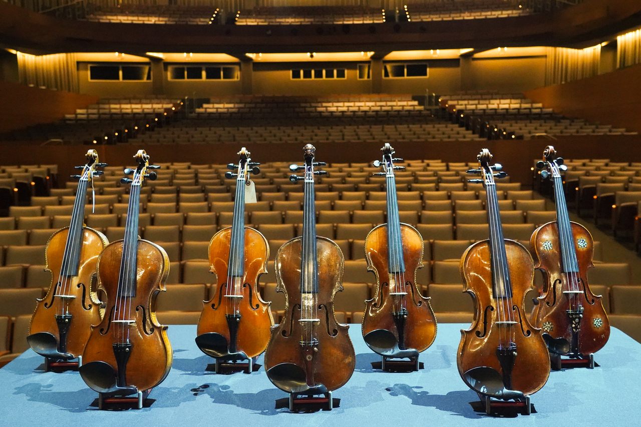 Some of the Violins of Hope on the stage of The Soraya. 