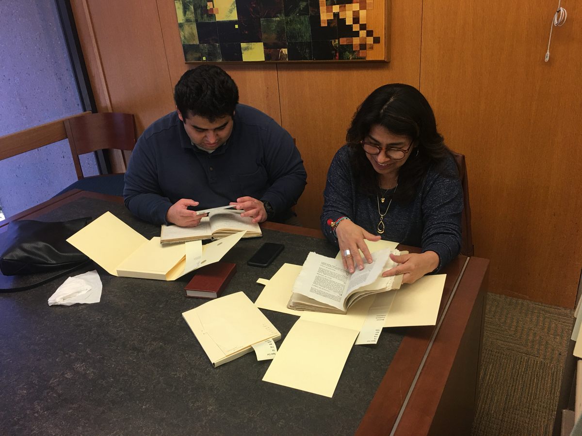 Food blogger Mely Martinez and her son browse the cookbook collection.