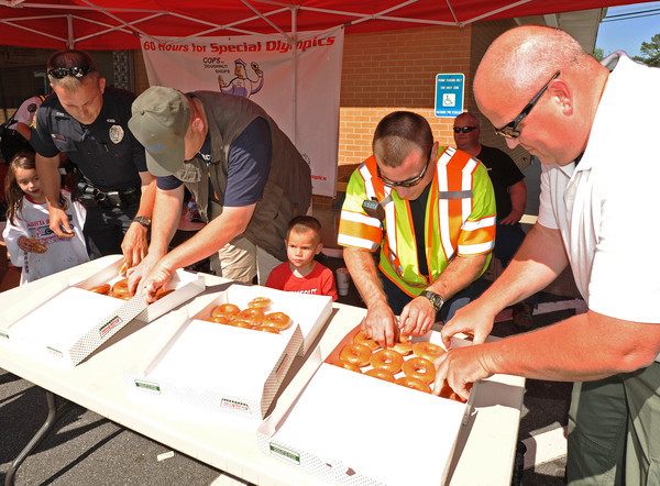 Members of Georgia's Mariettta Police Department give out donuts at an annual fundraiser.