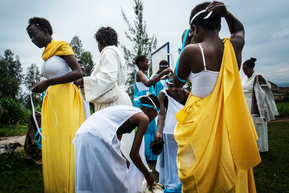 A group of women prepare for the special mass. During the celebration around the church there is music, dancing, and hymns.