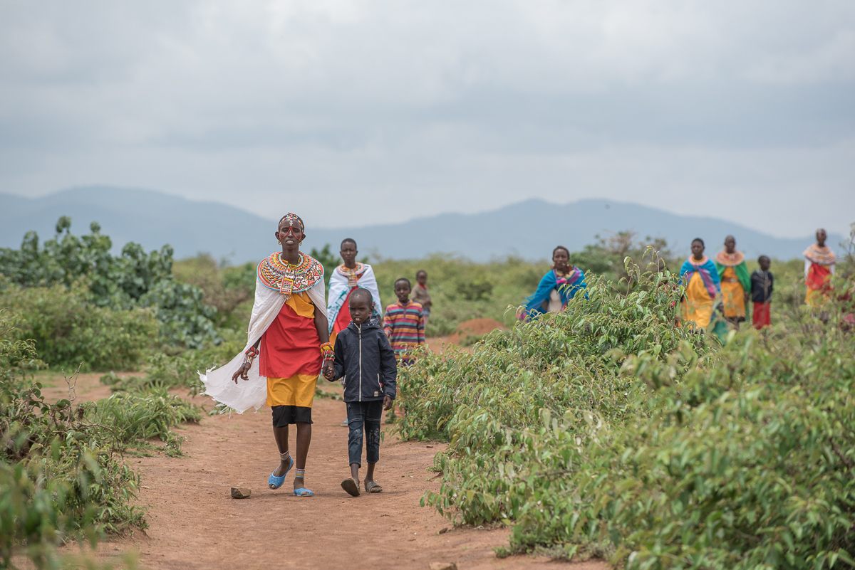 Samburu women and their children walking near Kirisia forest.