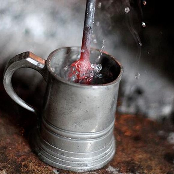 A red-hot loggerhead is thrust into a mug.