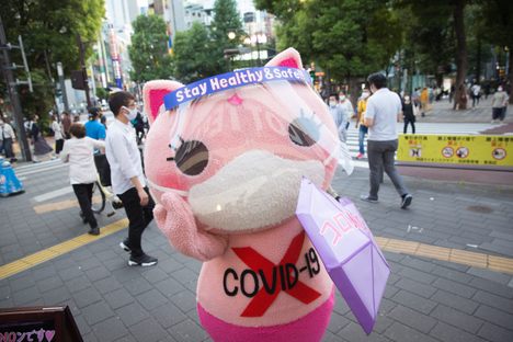 Koronon hands out face masks to encourage people to stay vigilant about COVID-19.