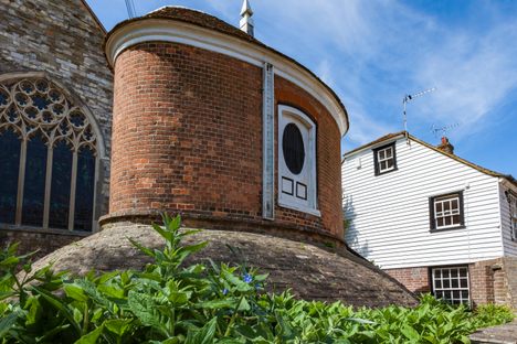 Historic 1736 Brick water tower in the Churchyard of The Parish Church of St Mary, Church Square, Rye, East Sussex, UK.