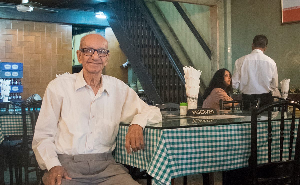 94-year-old Boman Kohinoor sits in his family's famous Britannia restaurant in the Fort neighborhood of South Mumbai. 