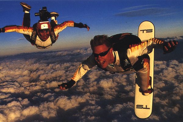 Troy Hartman surfs the skies as his cameraman flies by his side. 