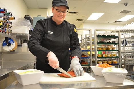 Chef Amy Foote preparing fresh Alaskan salmon for soup.