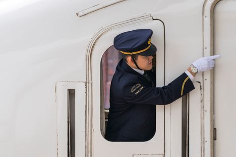 Guard on Shinkansen bullet train in Kyoto Station