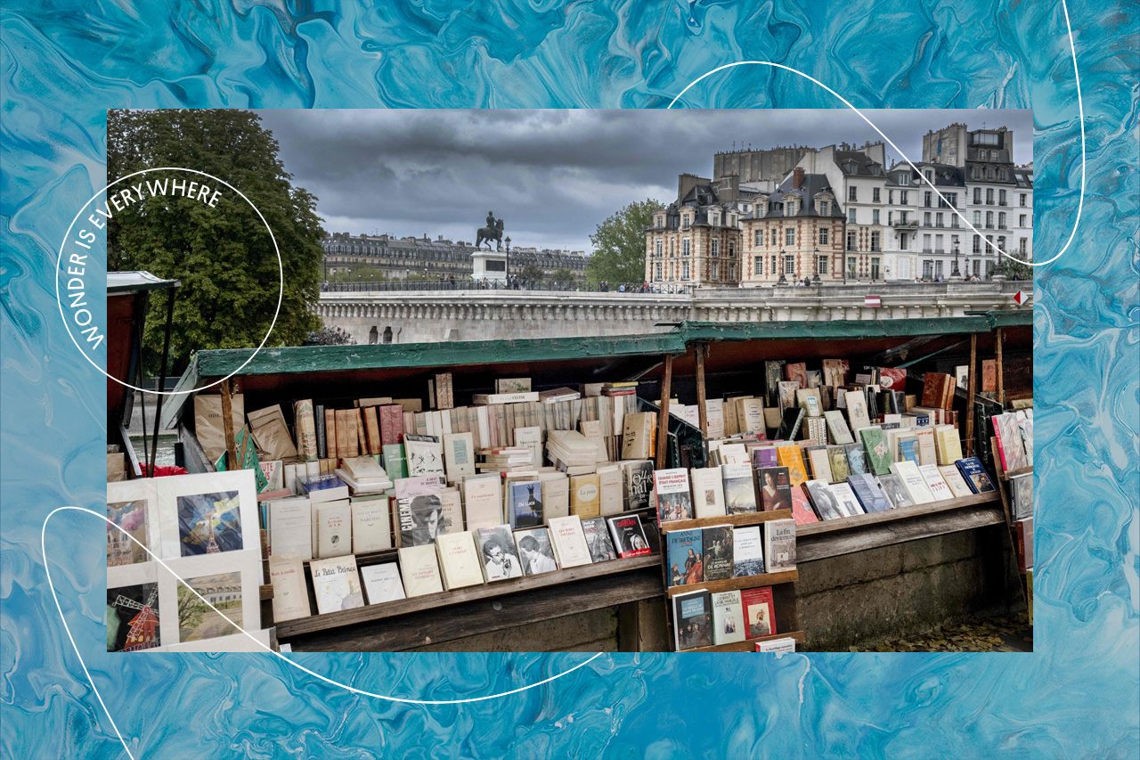 A <em>bouquiniste</em>, or traditional seller of vintage and antique books, on the bank of the Seine in Paris in August 2023. 