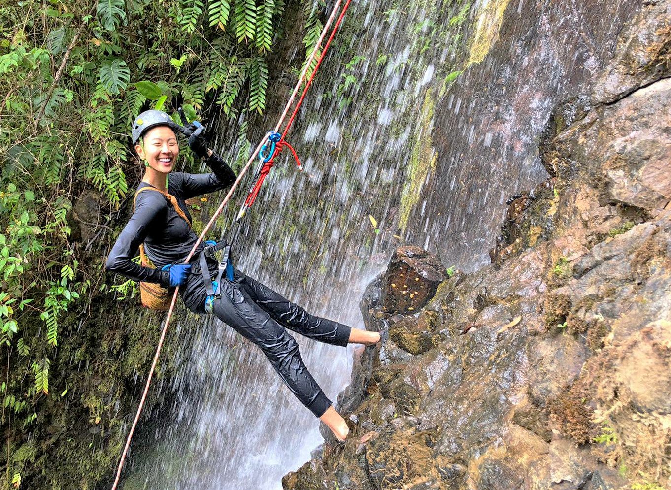 Kish rappels down a waterfall to collect a type of fresh watercress that grows only in Hacienda Mamecillo, Panama.