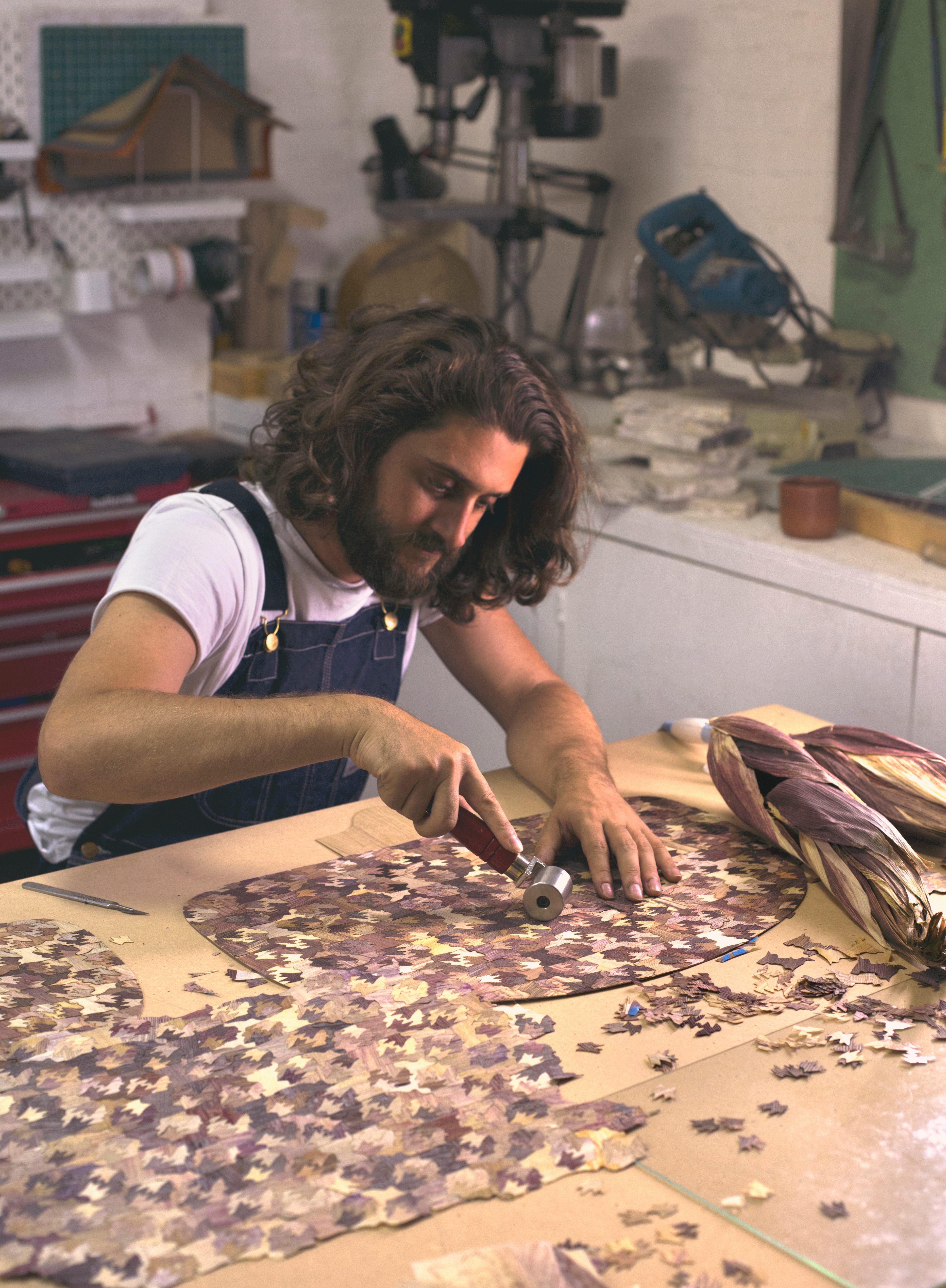 Laposse over a table of <em>Totomoxtle</em> marquetry.