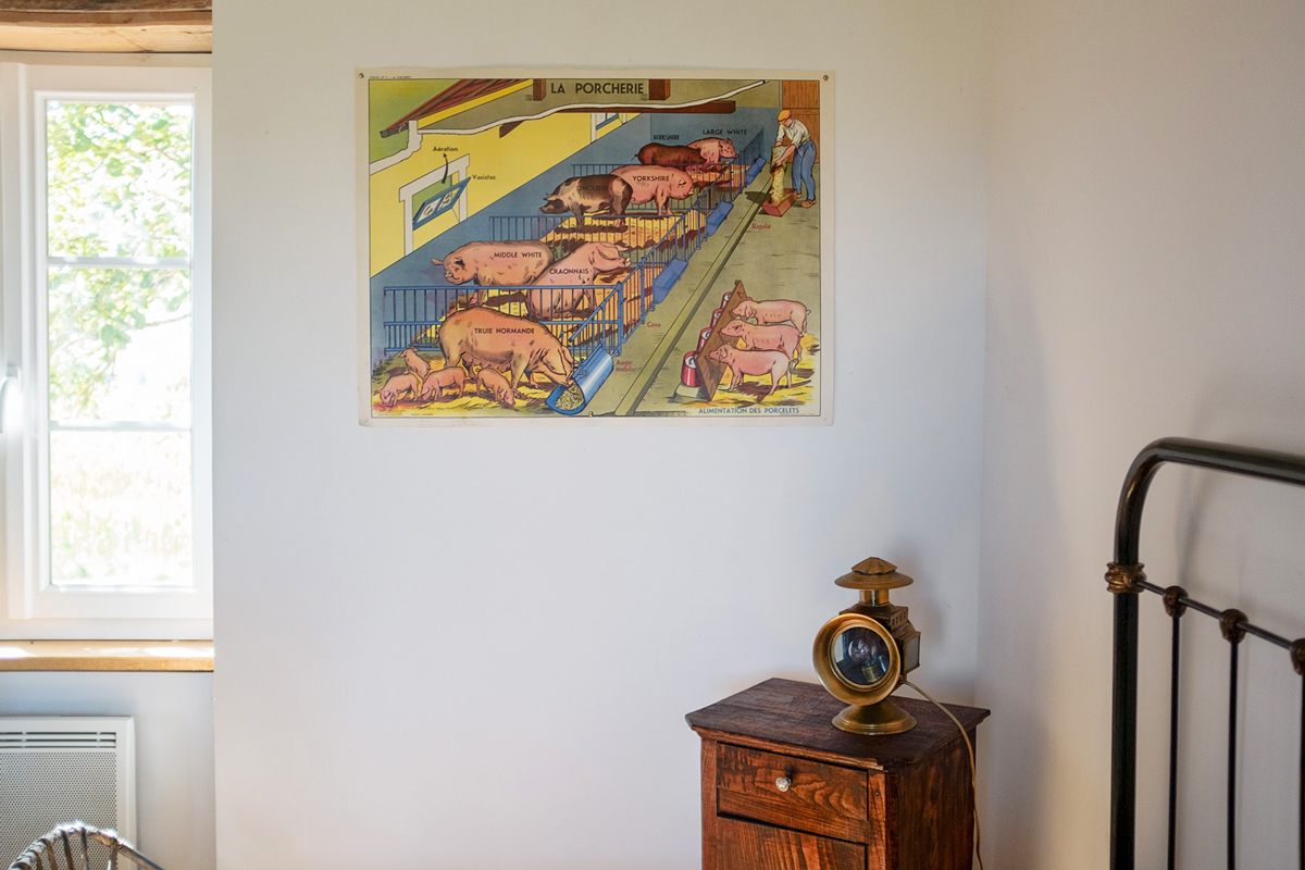 A poster showing a representation of a pig pen hangs in a room where the Bibal children stay during their visits the village.