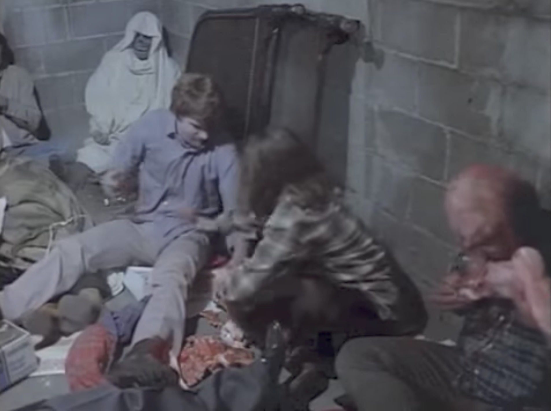 An Odd Fellows skeleton (top left) shows up in Dawn of the Dead, wrapped in a sheet and surrounded by zombies.