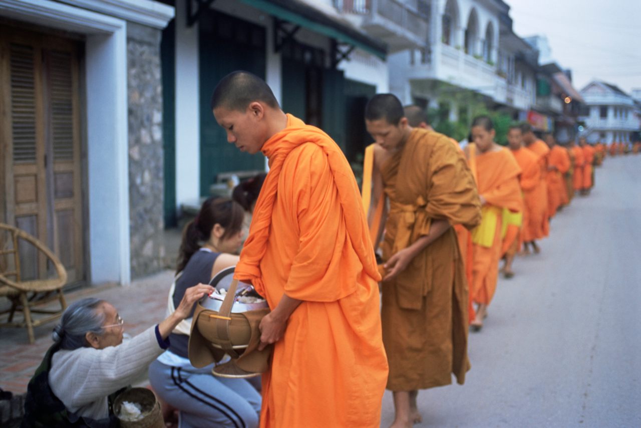 Buddhist monks collecting alms of rice in Luang Prabang, Laos.