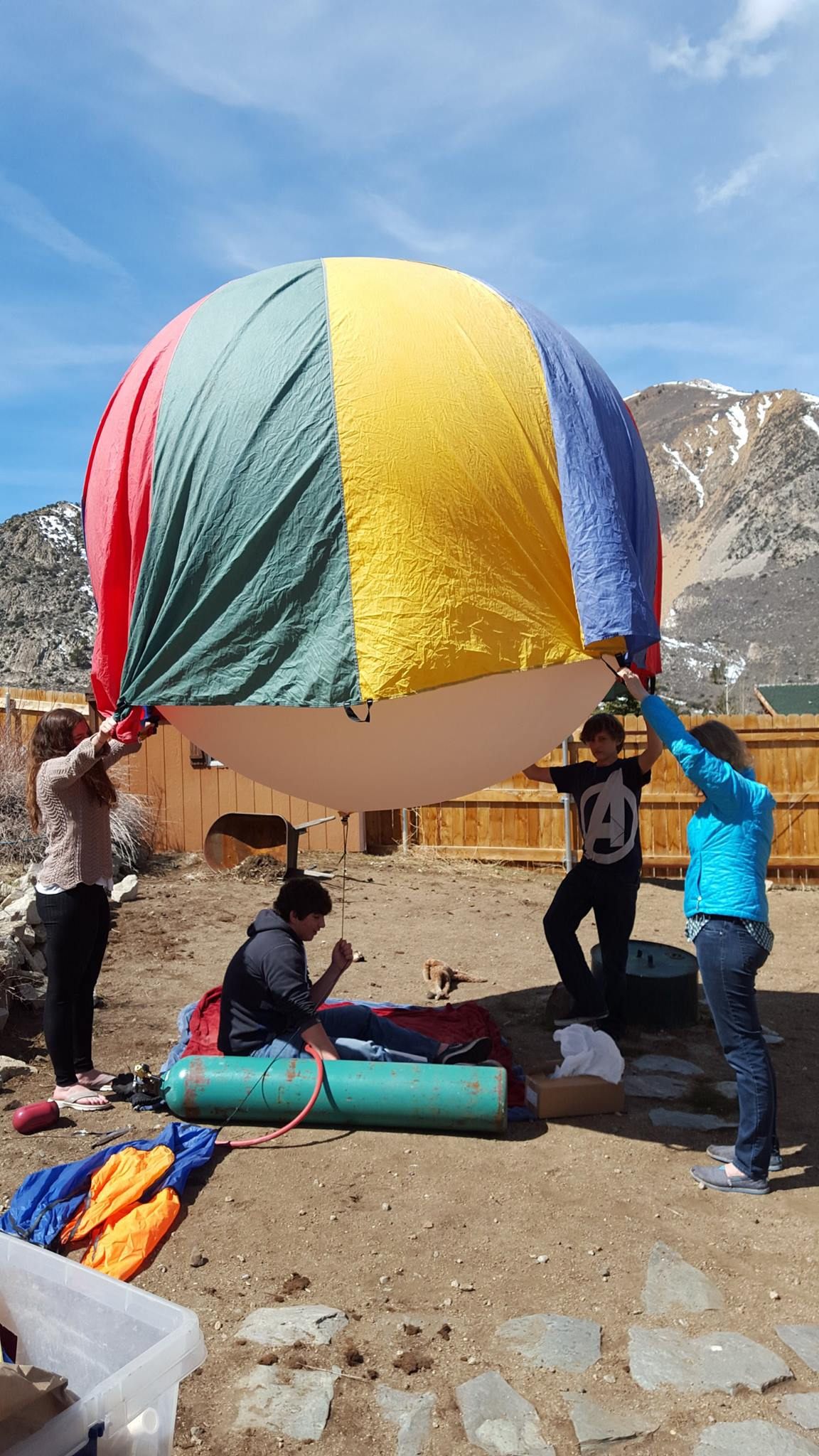 Three Earth To Sky members, holding the balloon down until the right moment.