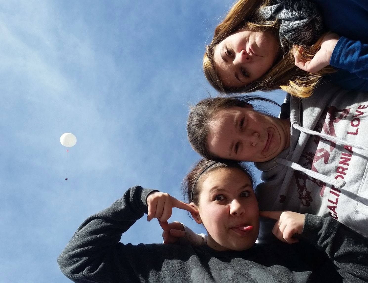 A trio of Earth to Sky Calculus members, with their handiwork in the background.