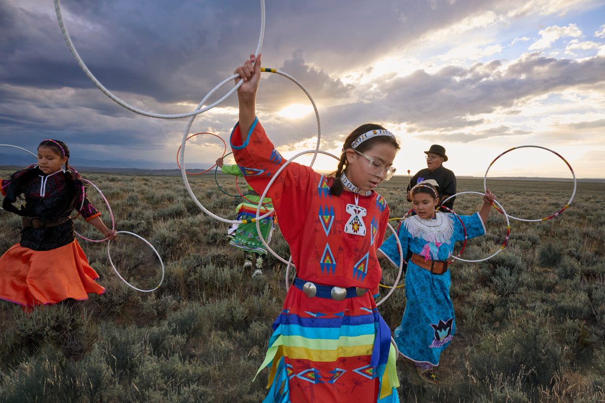 Hoop Dancers performing on the native landscape.