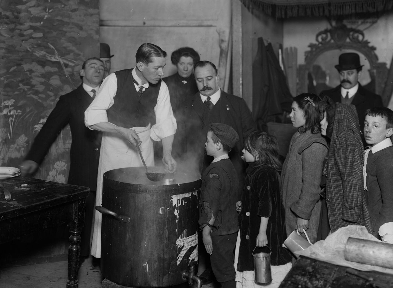 Children lining up for soup at the Canterbury Music Hall in 1910.