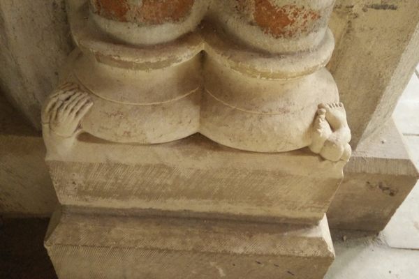 The crushed guy is at the bottom of the pillar behind the St. Thomas Aquinas reliquary