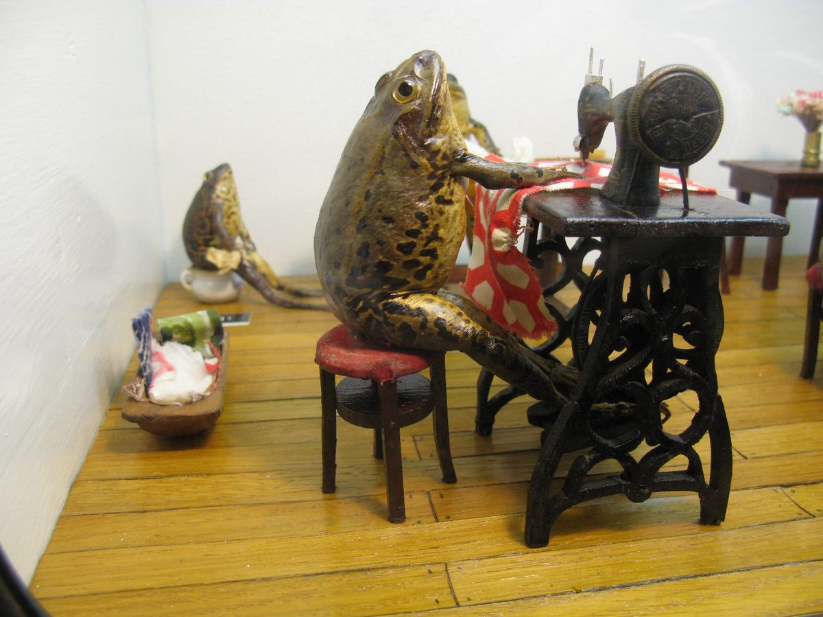 A stuffed frog sewing.