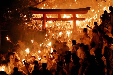Men called noboriko—more than 1,500 of them—run down the 538 stone steps of the Kumano Hayatama Taisha Shrine during the Oto Fire Festival in Shingu, Wakayama, Japan, to celebrate the end of winter. (2020)