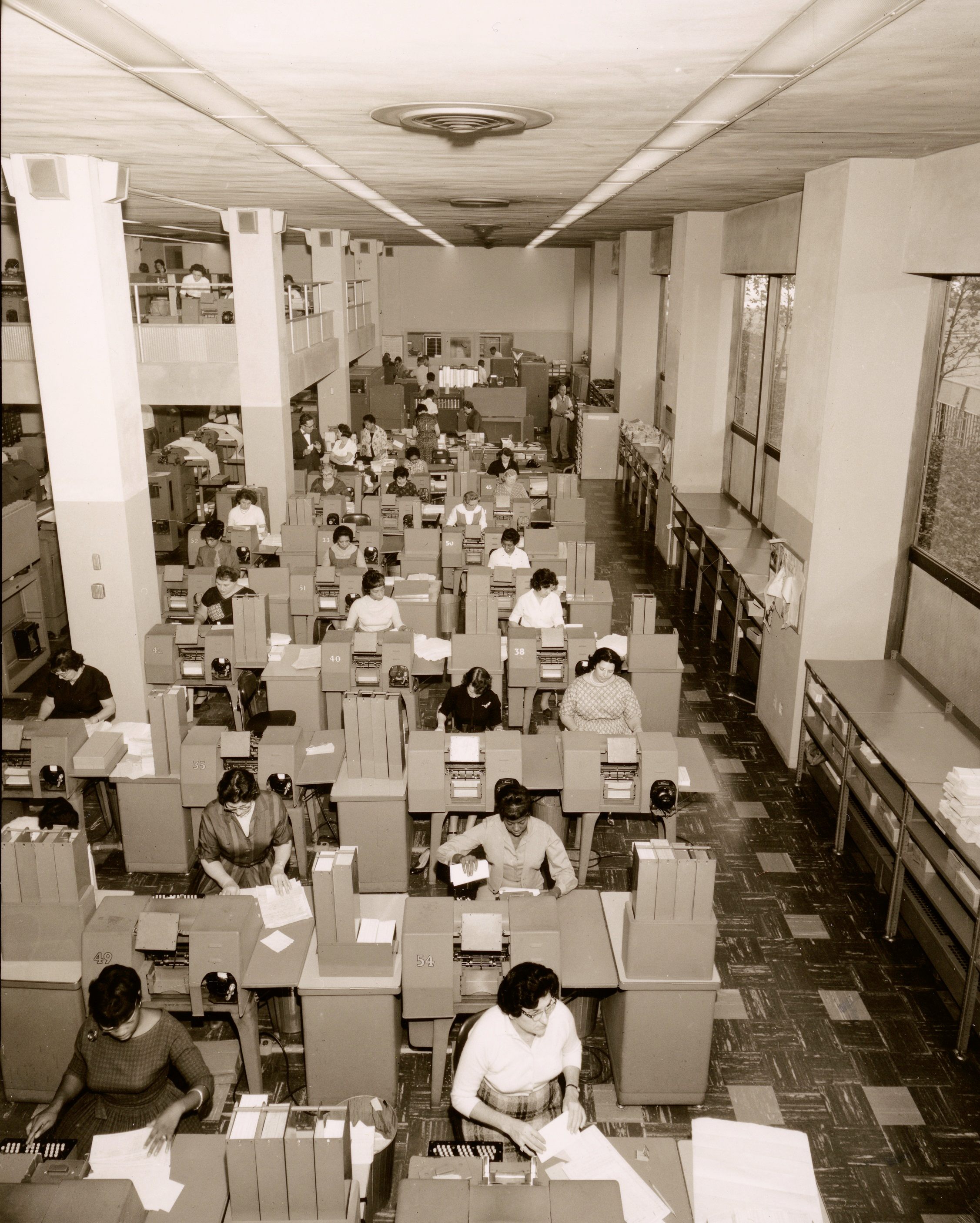 The data processing rooms were crammed with desks and largely staffed with female employees who processed documents that prompted and recorded the operations of the subway system. 1957.