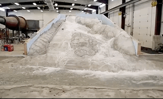The model of the damaged spillway in action.
