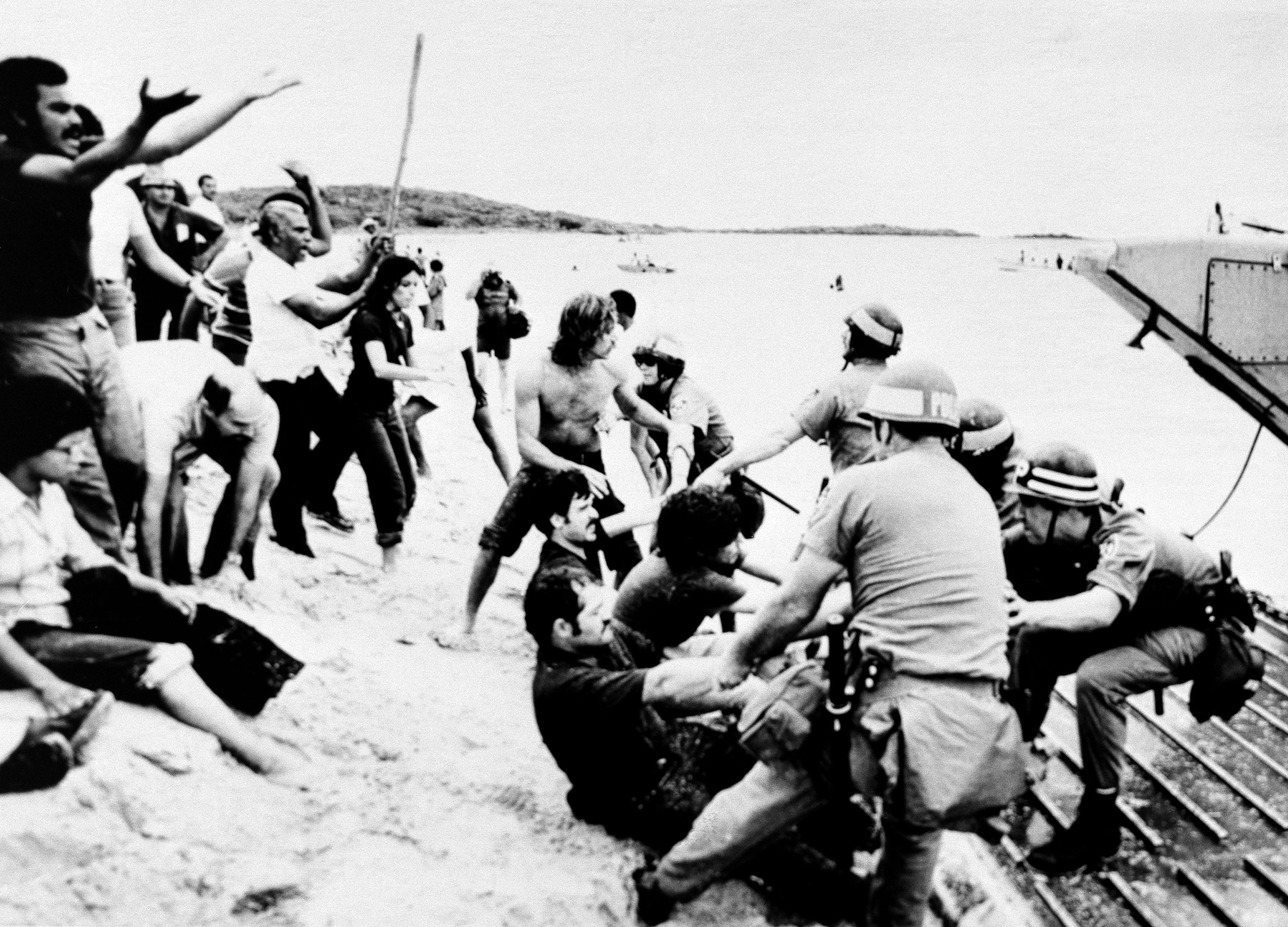 Navy police attempt to pull 21 people off their target practice area on the island of Vieques, Puerto Rico, May 20, 1979. Nearly 100 fishermen and sympathizers landed on the federal property in an attempt to interrupt Navy gunfire.