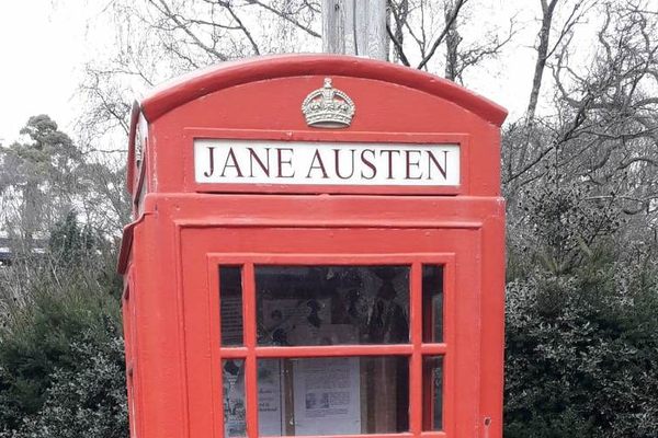 Jane Austen's name is emblazoned at the top of the telephone box.