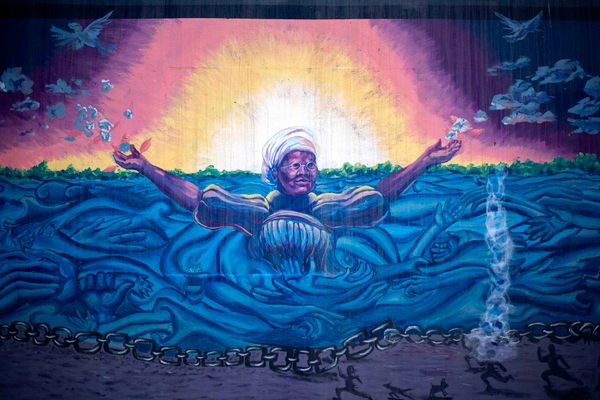 Meachum rises from the Mississippi River tossing cotton into the wind to symbolize freedom in this mural by St. Louis ArtWorks.