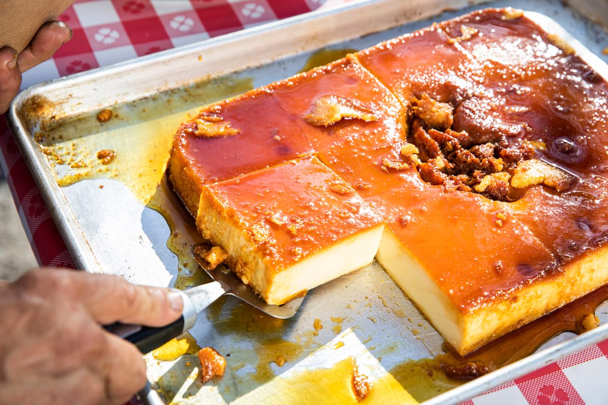 Noel Argote-Herrera serves flan to a customer.