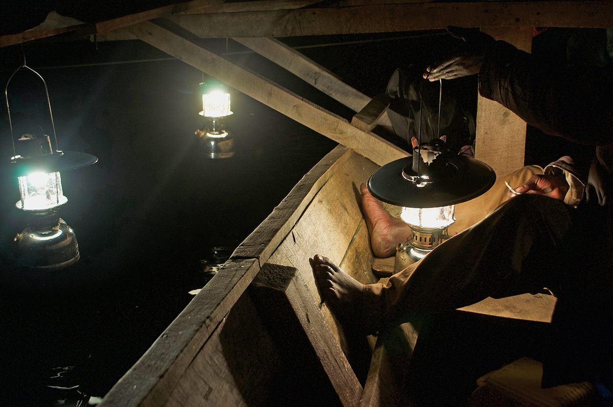 In place of rods, lanterns attract fish to waiting nets.