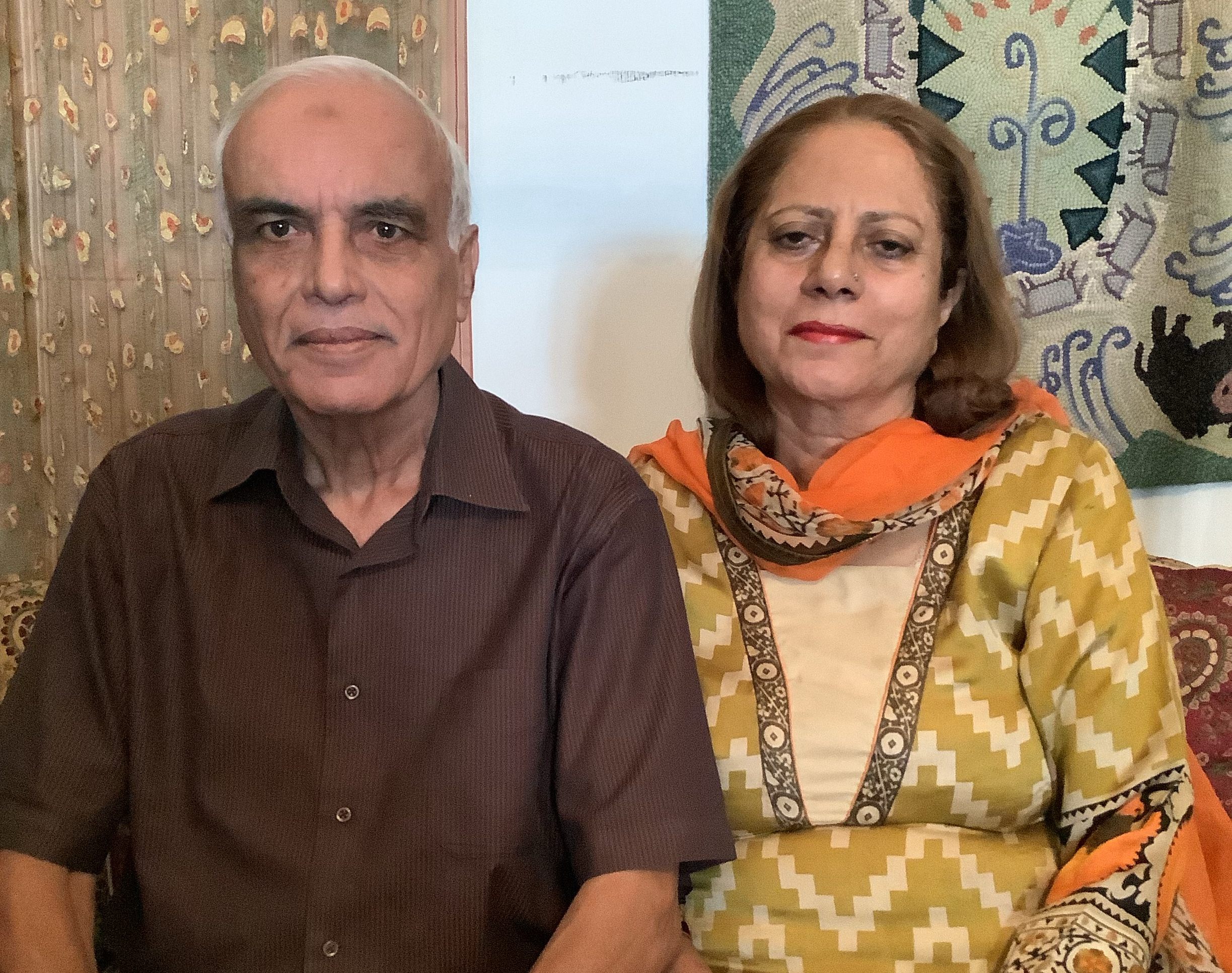 Khalid pictured with his wife, Tahira, in their home in Islamabad. The pandemic has prevented Khalid from traveling to the refinery, but he has continued his research into its history.