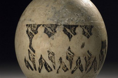Carved and painted ostrich egg showing Greek soldiers. 
