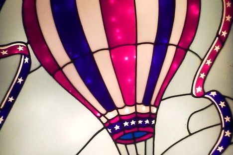 The hot air balloon stained glass in the back of the restaurant