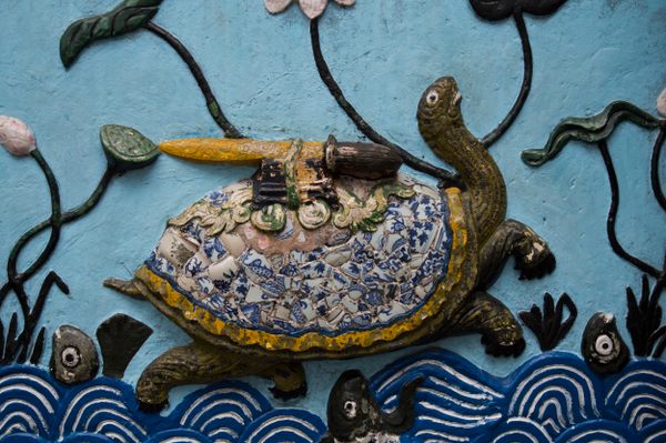 A relief at Ngọc Sơn Temple depicting the legendary turtle with a sword on its back.