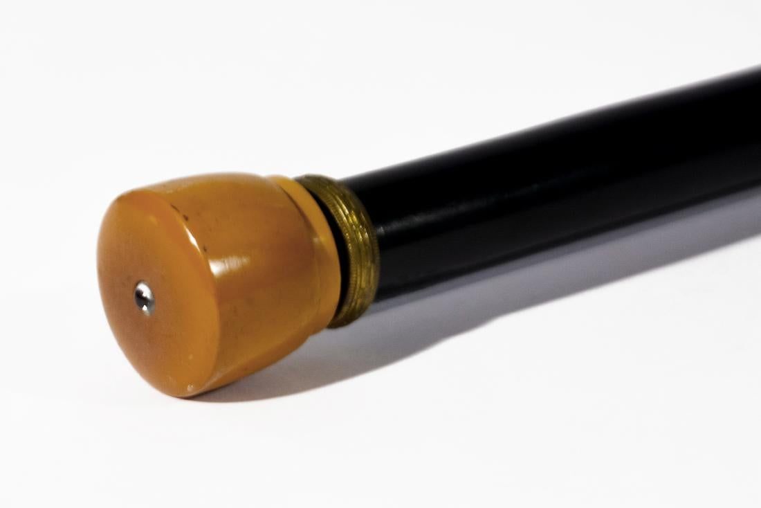 The cane's amber-colored bakelite head would emit a beam of light.