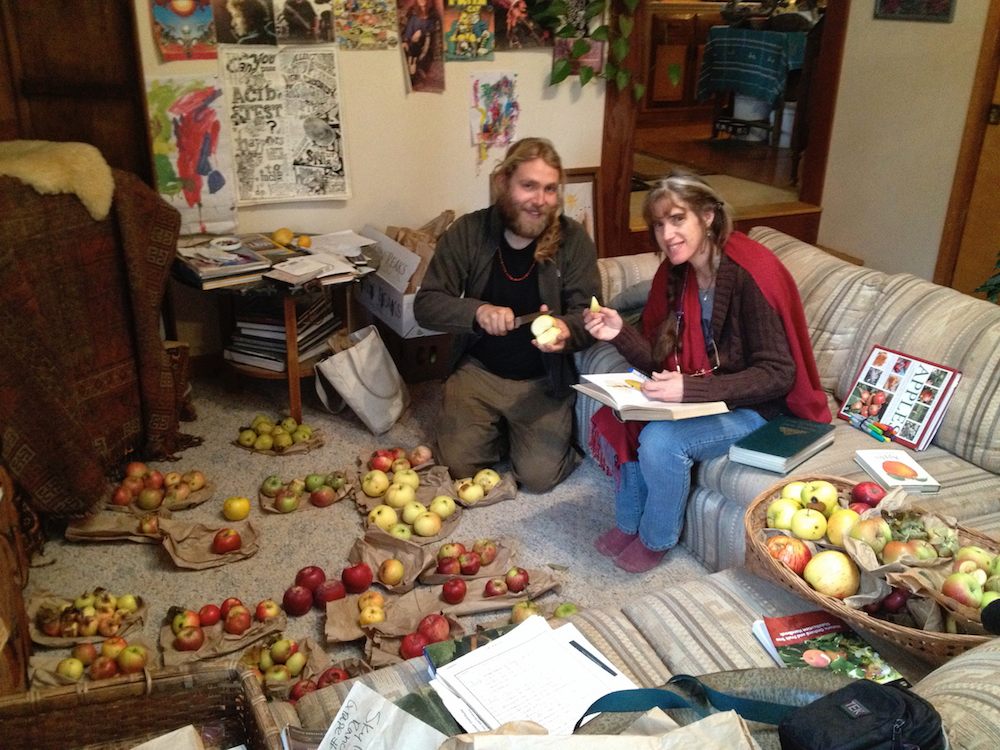 Adam Nuber and Jenifer Bliss, surrounded by a trove of apples.