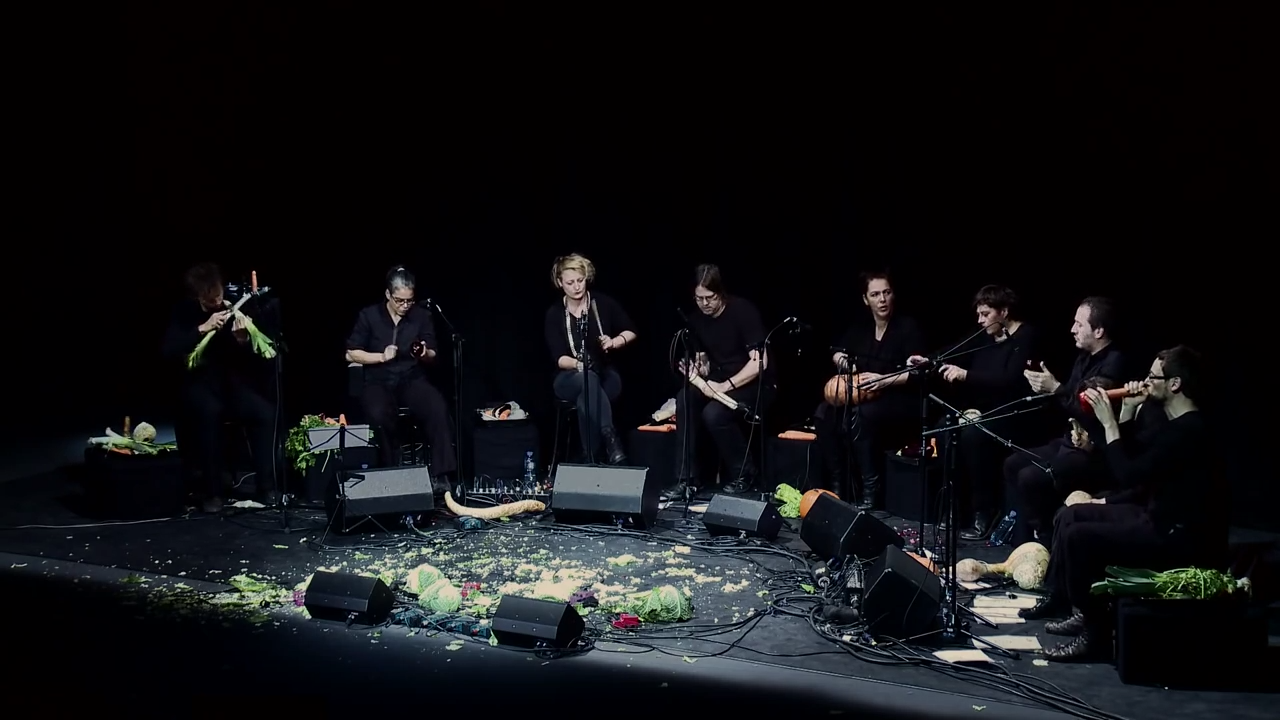 The Vegetable Orchestra performing at TEDx, with the remains of shredded cabbage at their feet.